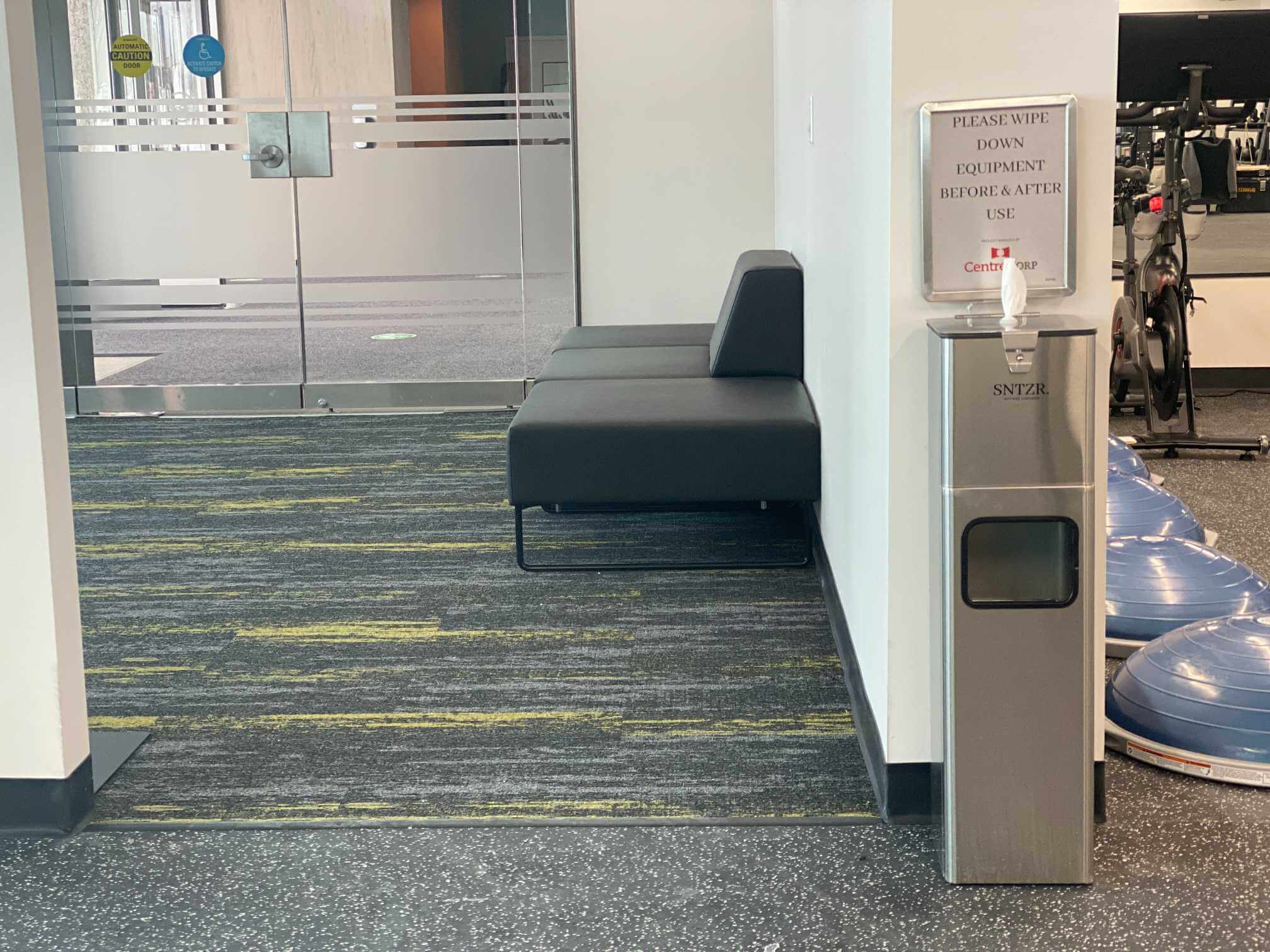 Commercial wipe dispenser installed in a fitness facility